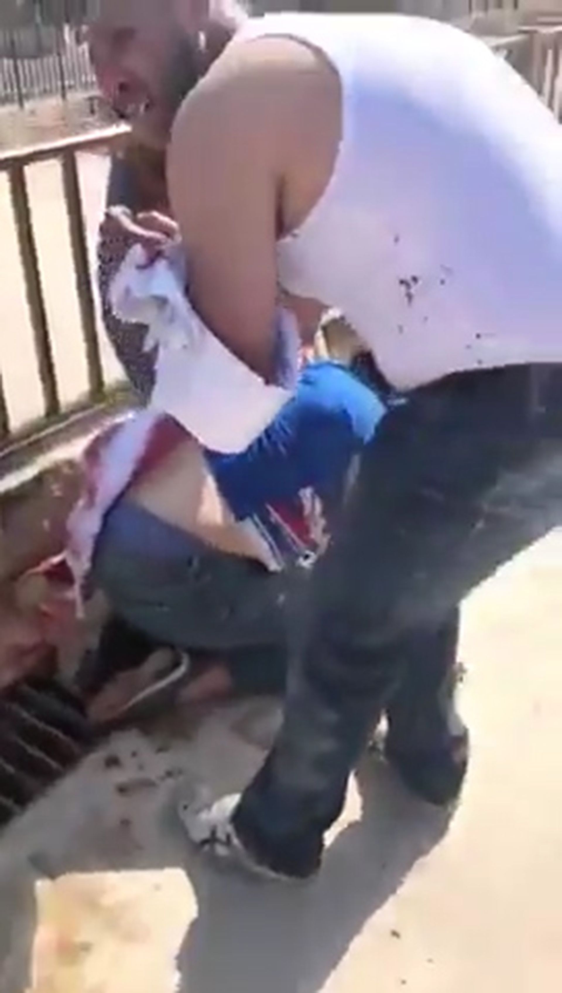 En un vídeo difundido en las redes sociales, se puede ver a una mujer tendida en el suelo bocabajo con una herida en la espalda (Foto: Twitter)