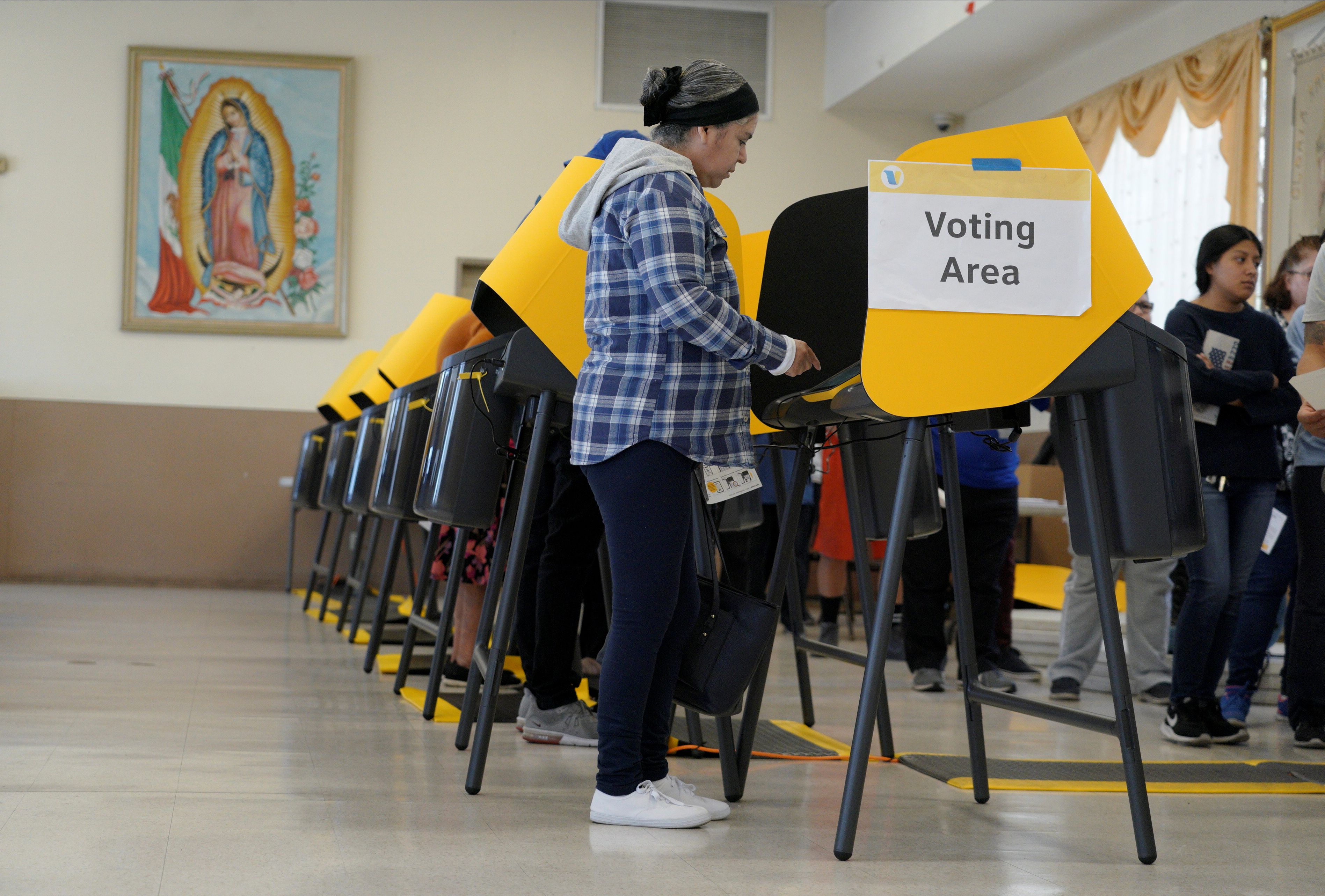 Voters make their choices for Democratic presidential nominee during Super Tuesday elections at a polling place inside Assumption Church in the Boyle Heights neighborhood of Los Angeles, California, U.S., March 3, 2020. REUTERS/Kyle Grillot