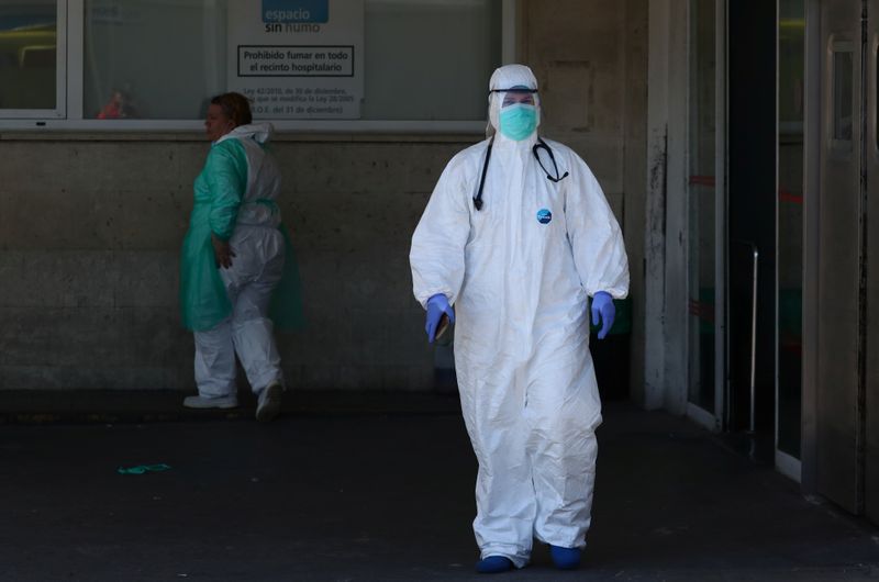 A healthcare worker is seen near the emergency unit at 12 de Octubre hospital during the coronavirus disease (COVID-19) outbreak in Madrid, Spain March 28, 2020. REUTERS/Sergio Perez