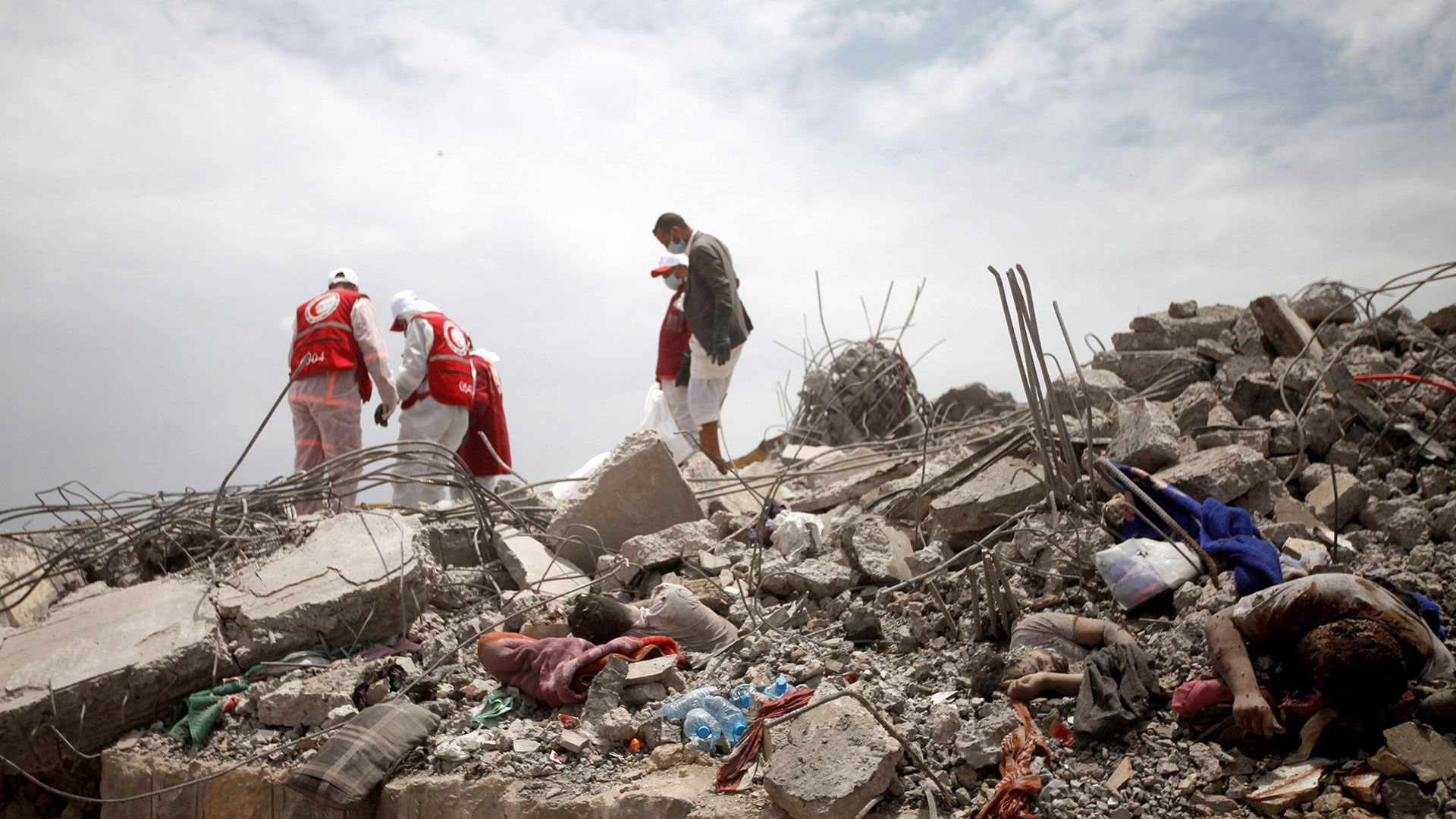 Médicos de la Cruz Roja buscan sobrevivientes entre los escombros en el lugar de los ataques aéreos dirigidos por fuerzas sauditas contra un centro de detención huti en Dhamar, Yemen, el 2 de septiembre de 2019 (REUTERS/Mohamed al-Sayaghi)