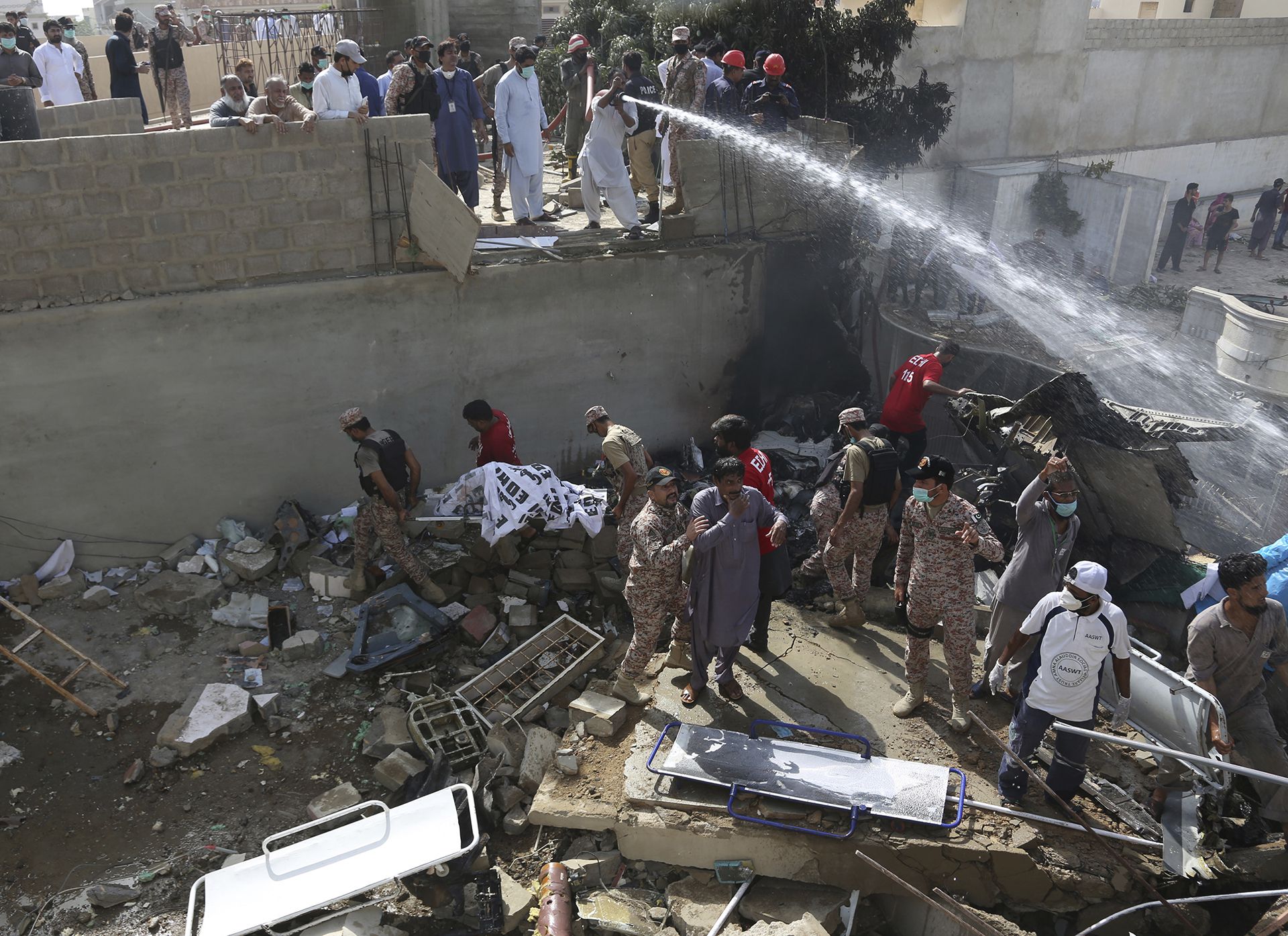 Bomberos apagan el fuego (AP Photo/Fareed Khan)