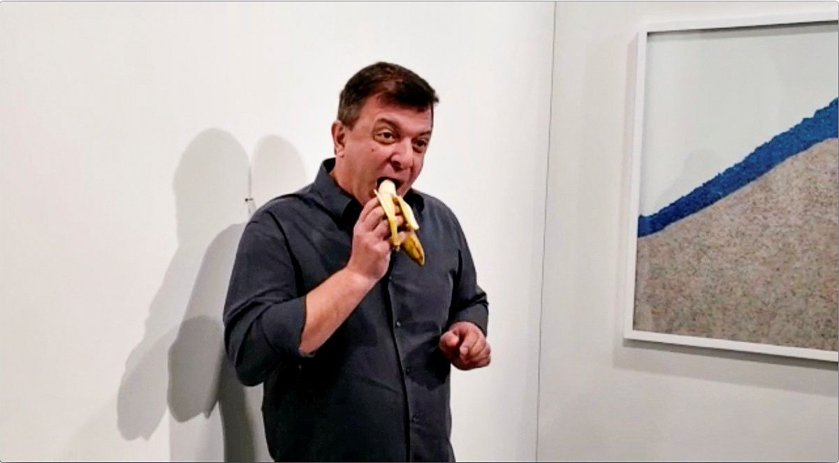 David Datuna se come la banana en el Art Basel de Miami Beach, en 2019 (Ronn Torossian via REUTERS)