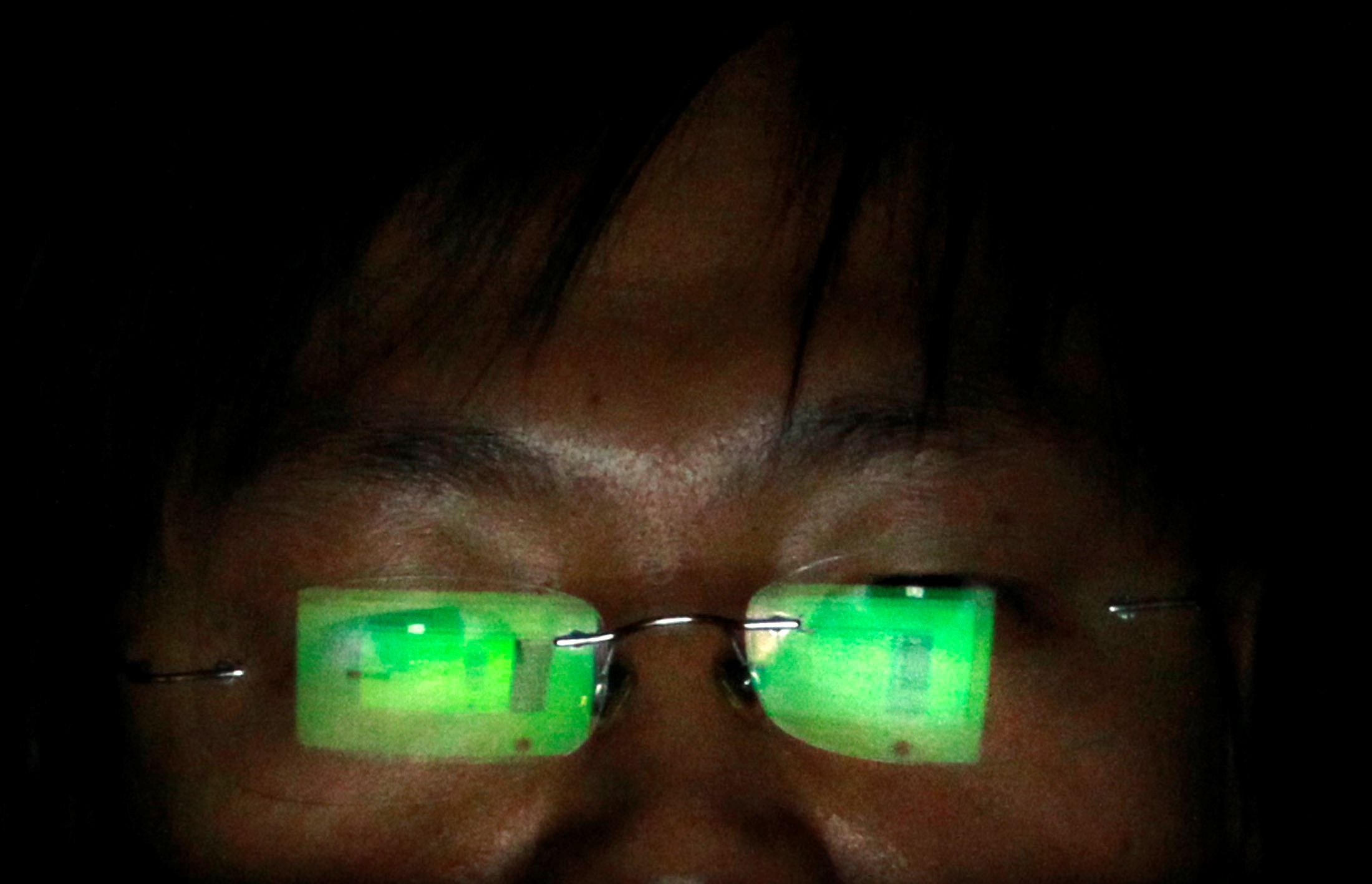 FILE PHOTO: A hacker, who asked not to have his name revealed, works on his laptop in his office in Taipei July 10, 2013. REUTERS/Pichi Chuang/File Photo