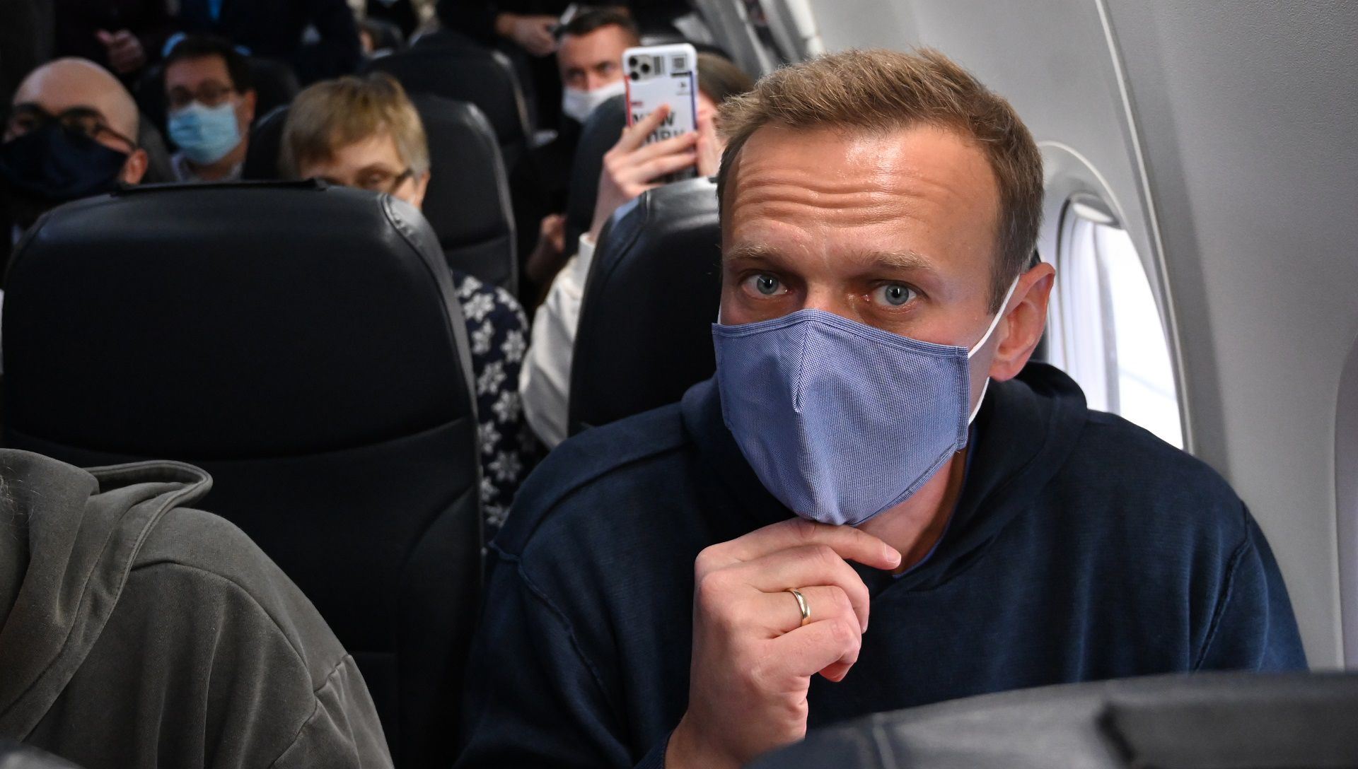 Russian opposition leader Alexei Navalny sits in a Pobeda airlines plane heading to Moscow before take-off from Berlin Brandenburg Airport (BER) in Schoenefeld, southeast of Berlin, on January 17, 2021. - Chief Kremlin critic Alexei Navalny returns to Russia from Germany on January 17, facing imminent arrest after authorities warned they would detain him. The 44-year-old opposition leader is flying back to Moscow after spending several months in Germany recovering from a poisoning attack that he said was carried out on the orders of President Vladimir Putin. (Photo by Kirill KUDRYAVTSEV / AFP)