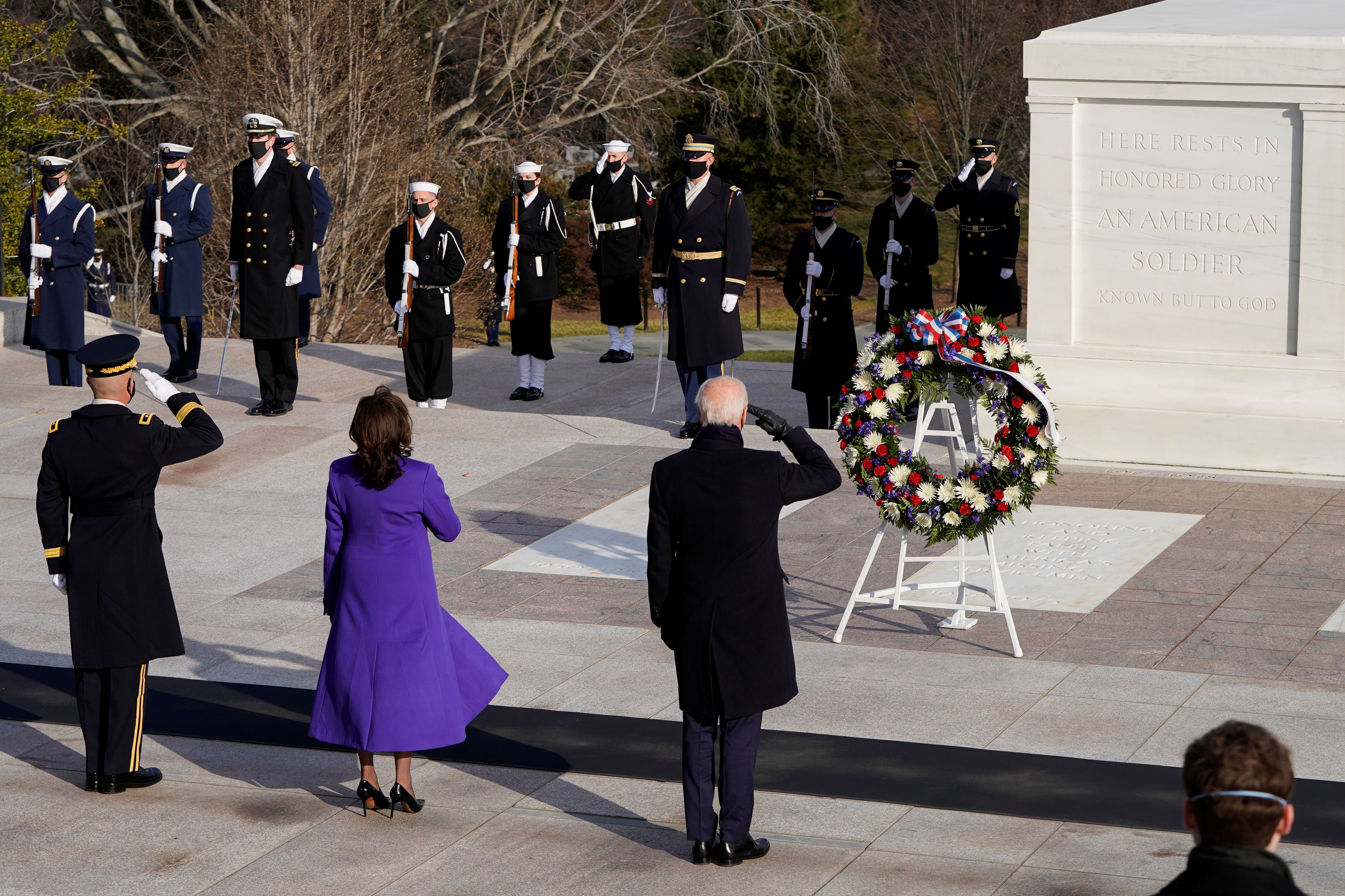 U.S. President Joe Biden, Vice President Kamala D. Harris and Major General Omar J. Jones salute at the Tomb of the Unknown Soldier at the Arlington National Cemetery, in Arlington, Virginia, U.S., January 20, 2021. REUTERS/Joshua Roberts/Pool