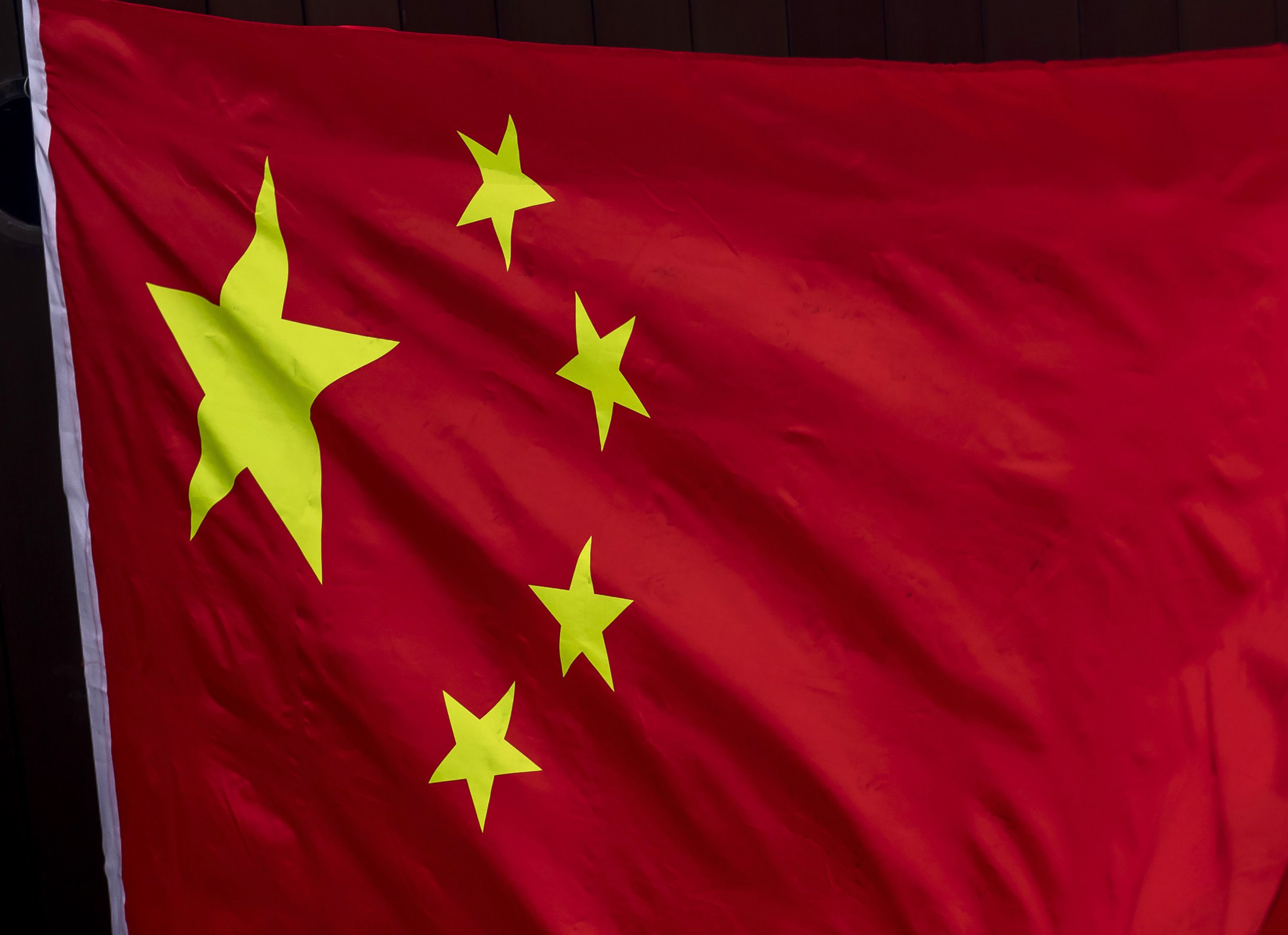 The flags of China, left, and of the Hong Kong Special Administrative Region (HKSAR) are displayed on a street in the Tsim Sha Tsui district in Hong Kong, China, on Monday, June 29, 2020. The national security law that China could impose on Hong Kong as early as this week won't need to be used if the financial hub's residents avoid crossing certain "red lines," according to Bernard Chan, a top adviser to Hong Kong Chief Executive Carrie Lam. Photographer: Paul Yeung/Bloomberg