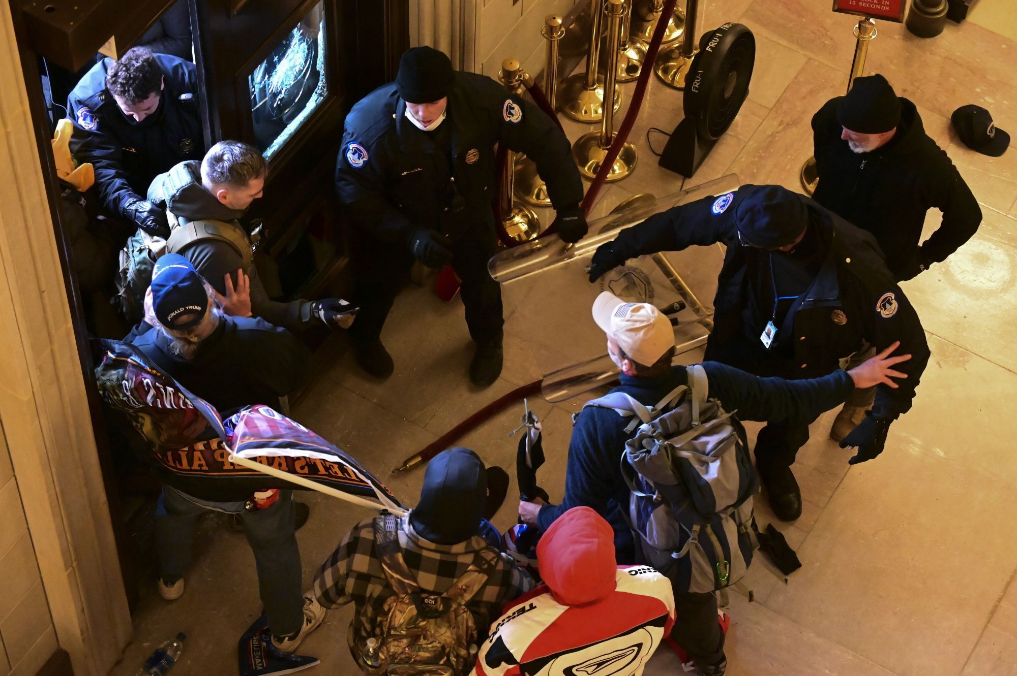 Demonstrators breach a door of the U.S. Capitol as a joint session of Congress to count the votes of the 2020 presidential election takes place in Washington, D.C., U.S., on Wednesday, Jan. 6, 2021. The U.S. Capitol was placed under lockdown and Vice President Mike Pence left the floor of Congress as hundreds of protesters swarmed past barricades surrounding the building where lawmakers were debating Joe Biden's victory in the Electoral College.