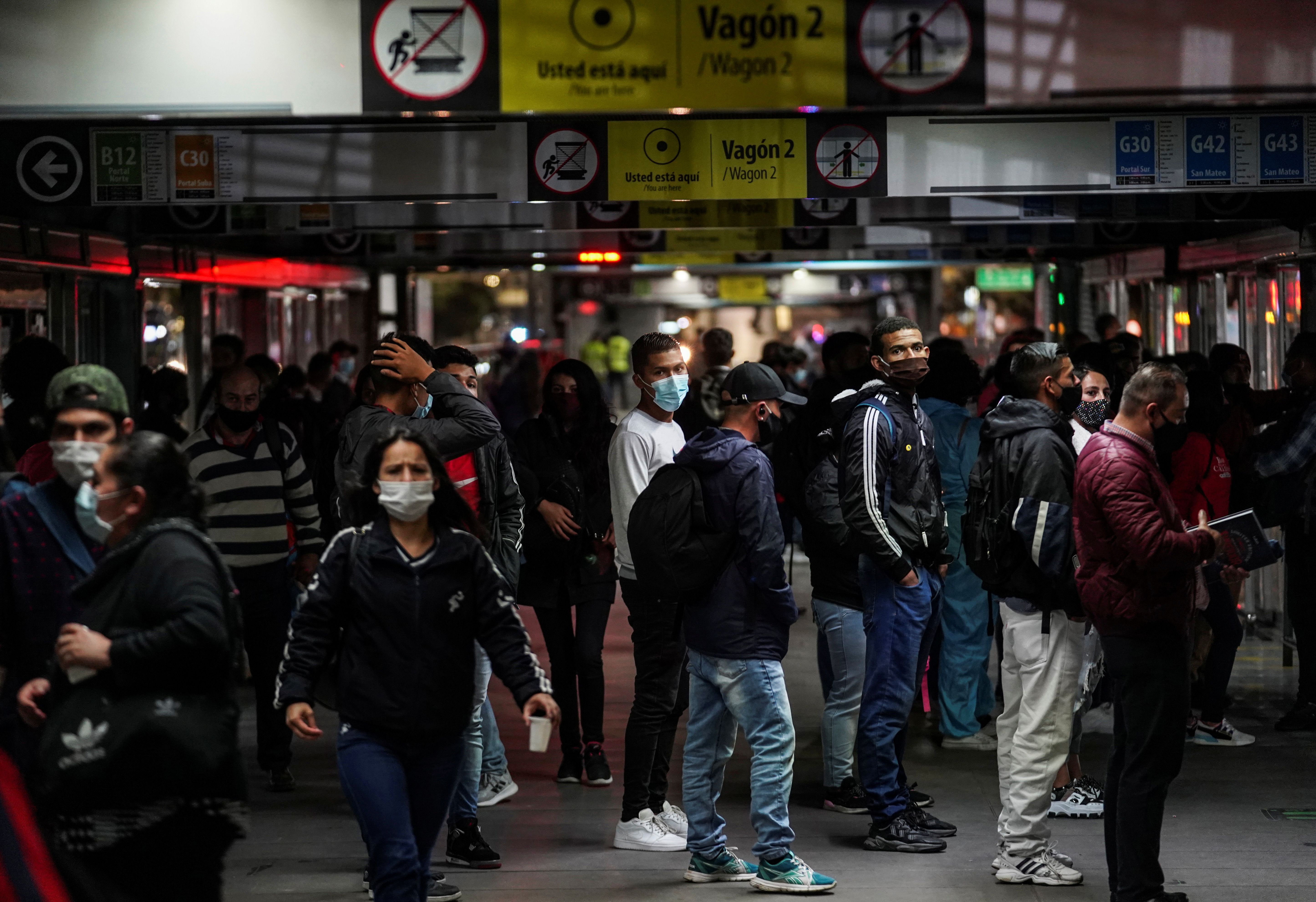 People wait to board a bus before a three-day lockdown ends on Tuesday in the capital of the country, to curb the spread of the coronavirus disease (COVID-19), in Bogota, Colombia April 12, 2021. REUTERS/Nathalia Angarita NO RESALES. NO ARCHIVES