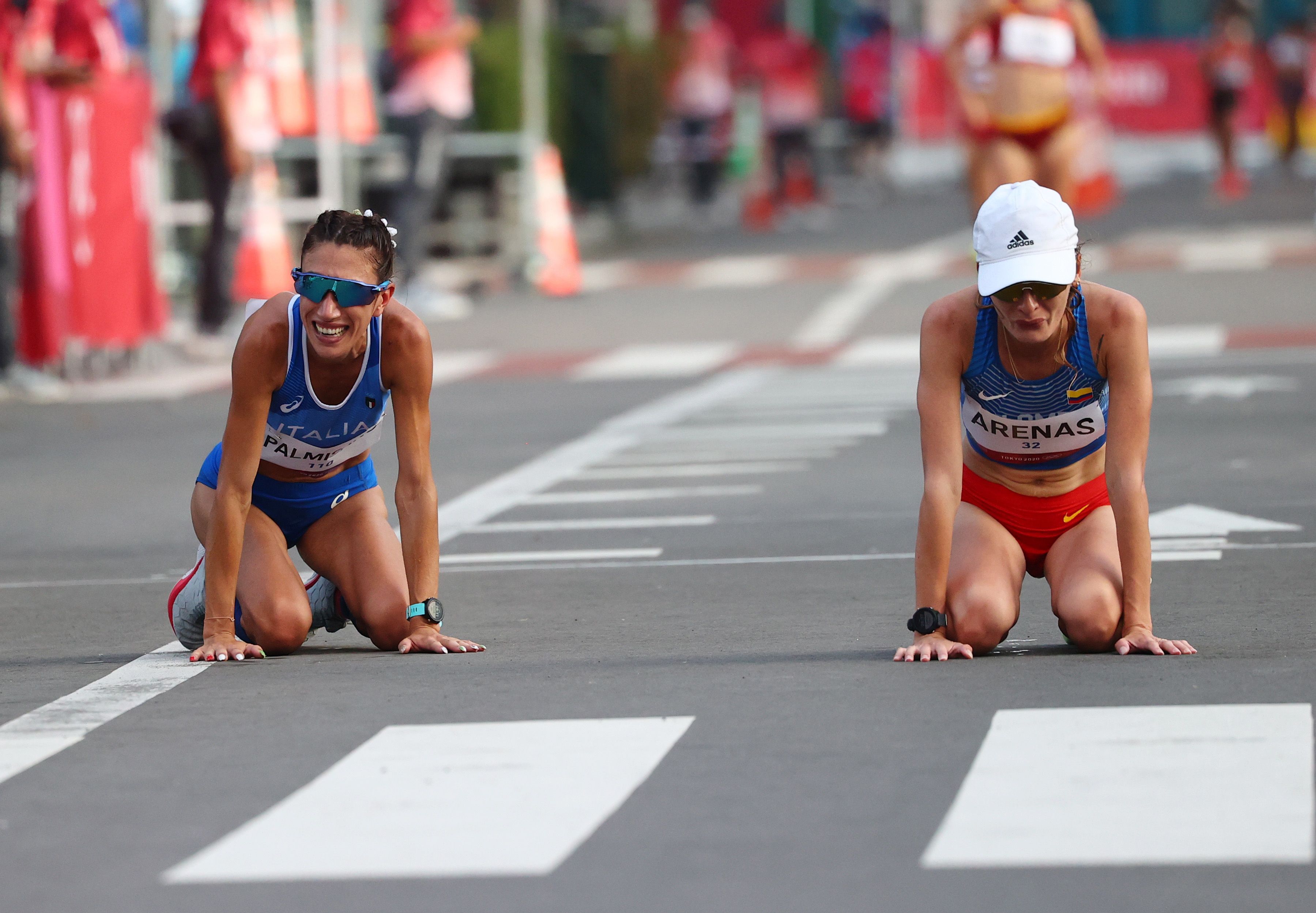 Tokyo 2020 Olympics - Athletics - Women's 20km Walk - Sapporo Odori Park, Sapporo, Japan - August 6, 2021. Gold medallist, Antonella Palmisano of Italy and silver medallist, Sandra Arenas of Colombia react after the race REUTERS/Feline Lim