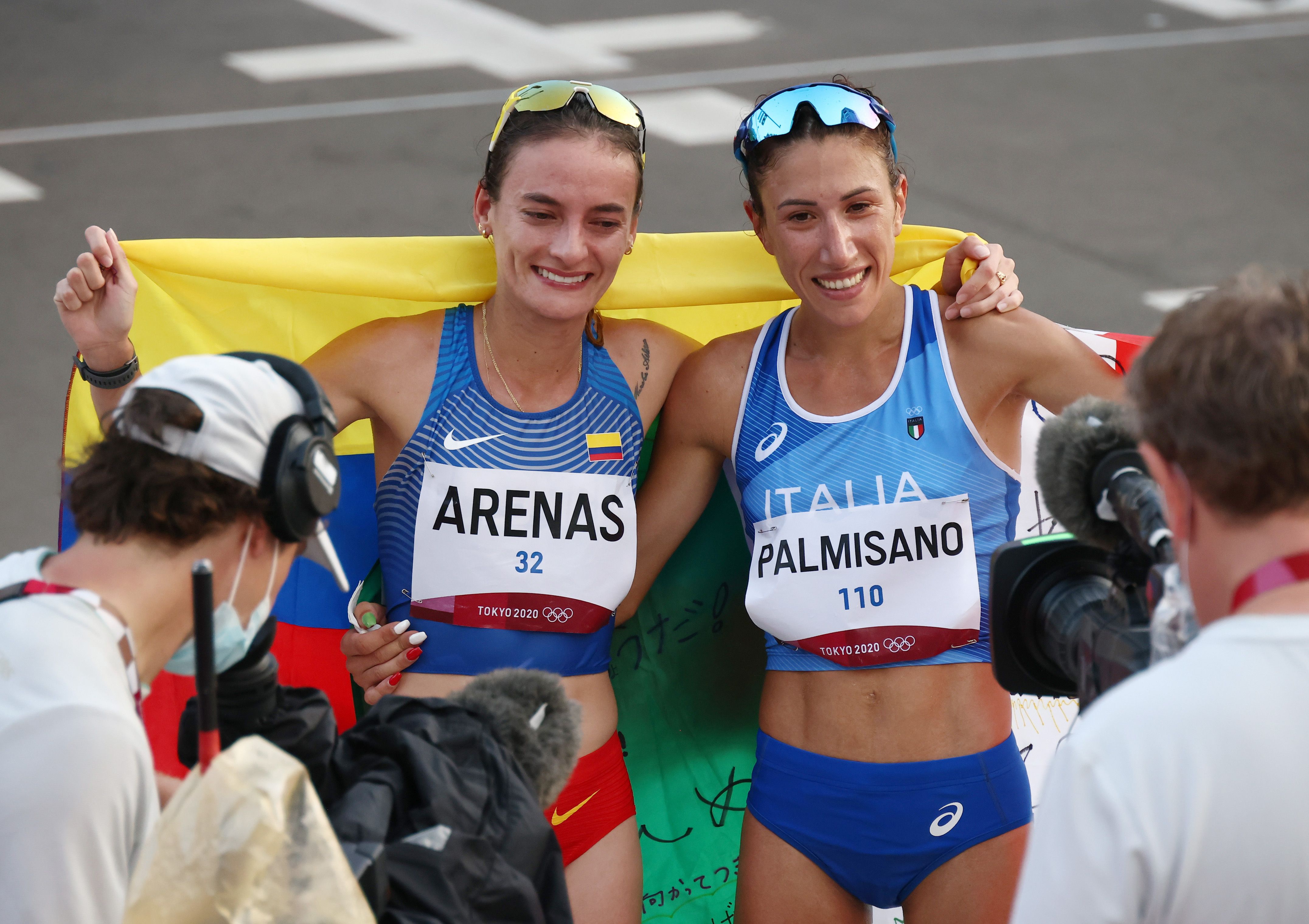 Tokyo 2020 Olympics - Athletics - Women's 20km Walk - Sapporo Odori Park, Sapporo, Japan - August 6, 2021. Gold medallist, Antonella Palmisano of Italy and silver medallist, Sandra Arenas of Colombia pose with their national flags after the race REUTERS/Kim Hong-Ji