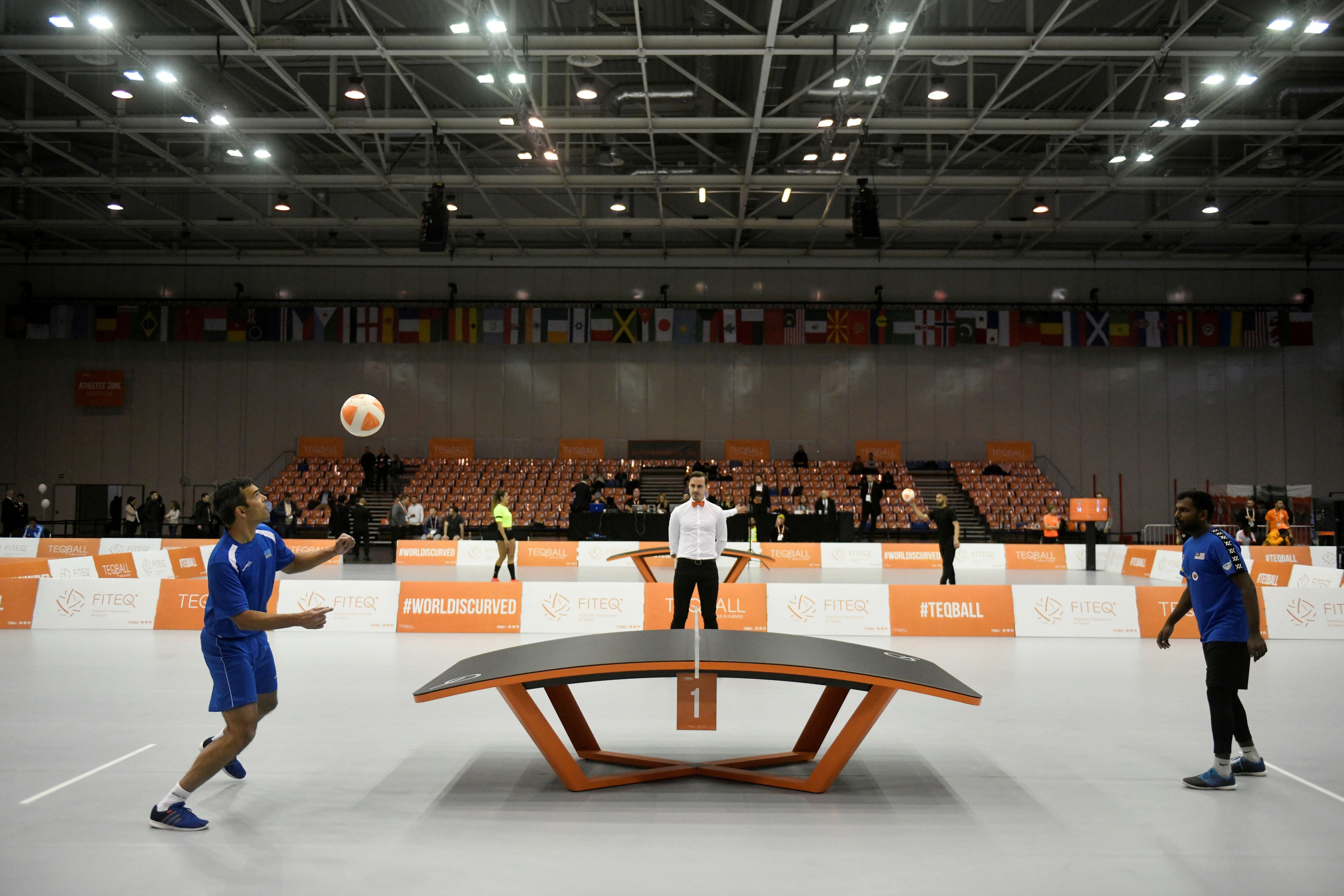 FILE PHOTO: Gregory Engelbrecht of Aruba and Al Barilan Shahul Hameed of Malaysia play teqball at the Teqball World Championships in Budapest, Hungary December 6, 2019. Picture taken December 6, 2019. REUTERS/Tamas Kaszas/File Photo