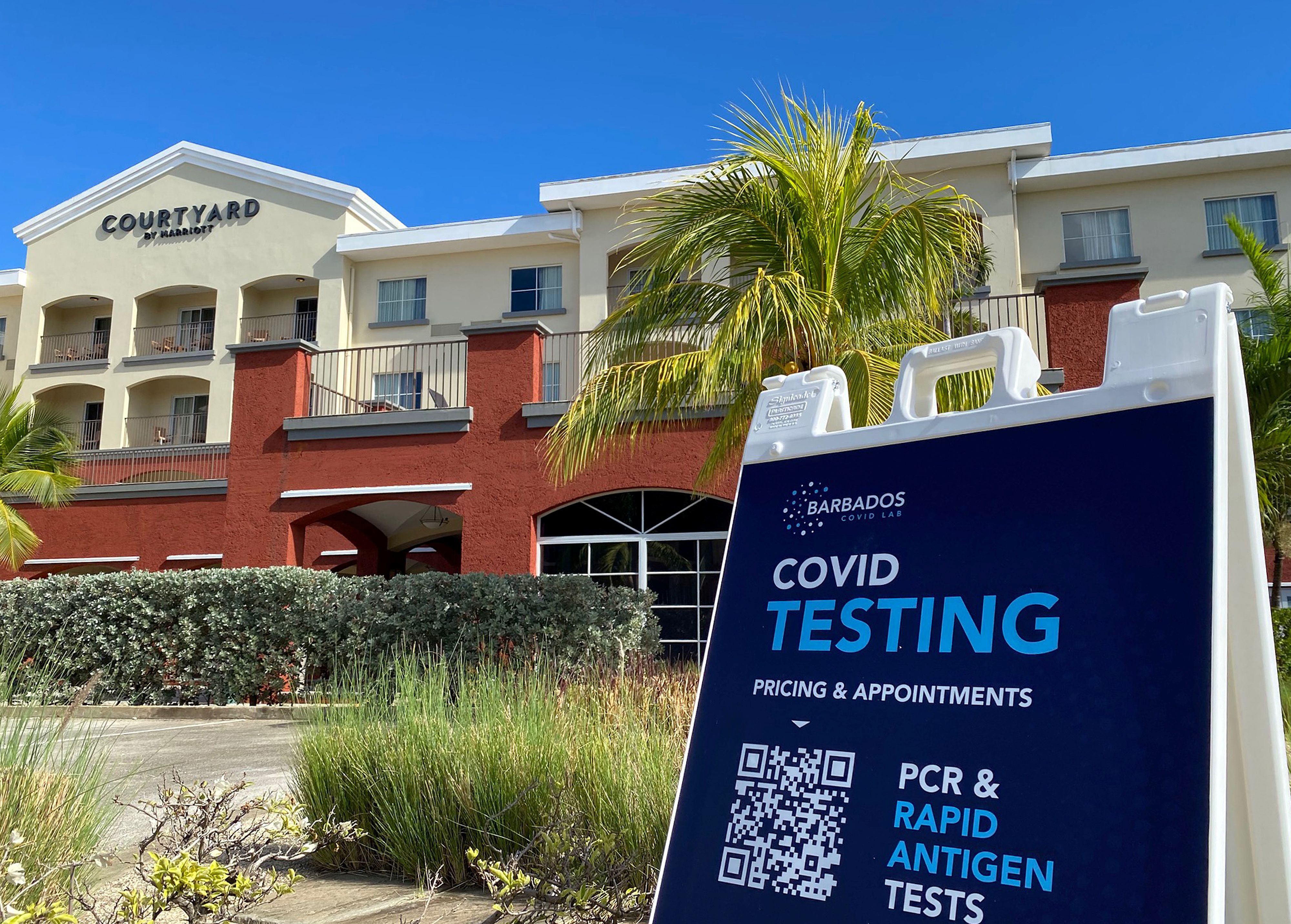 A COVID-19 testing sign is seen outside a hotel, amidst the spread of the coronavirus disease pandemic, in Bridgetown, Barbados, November 29, 2021. REUTERS/Toby Melville