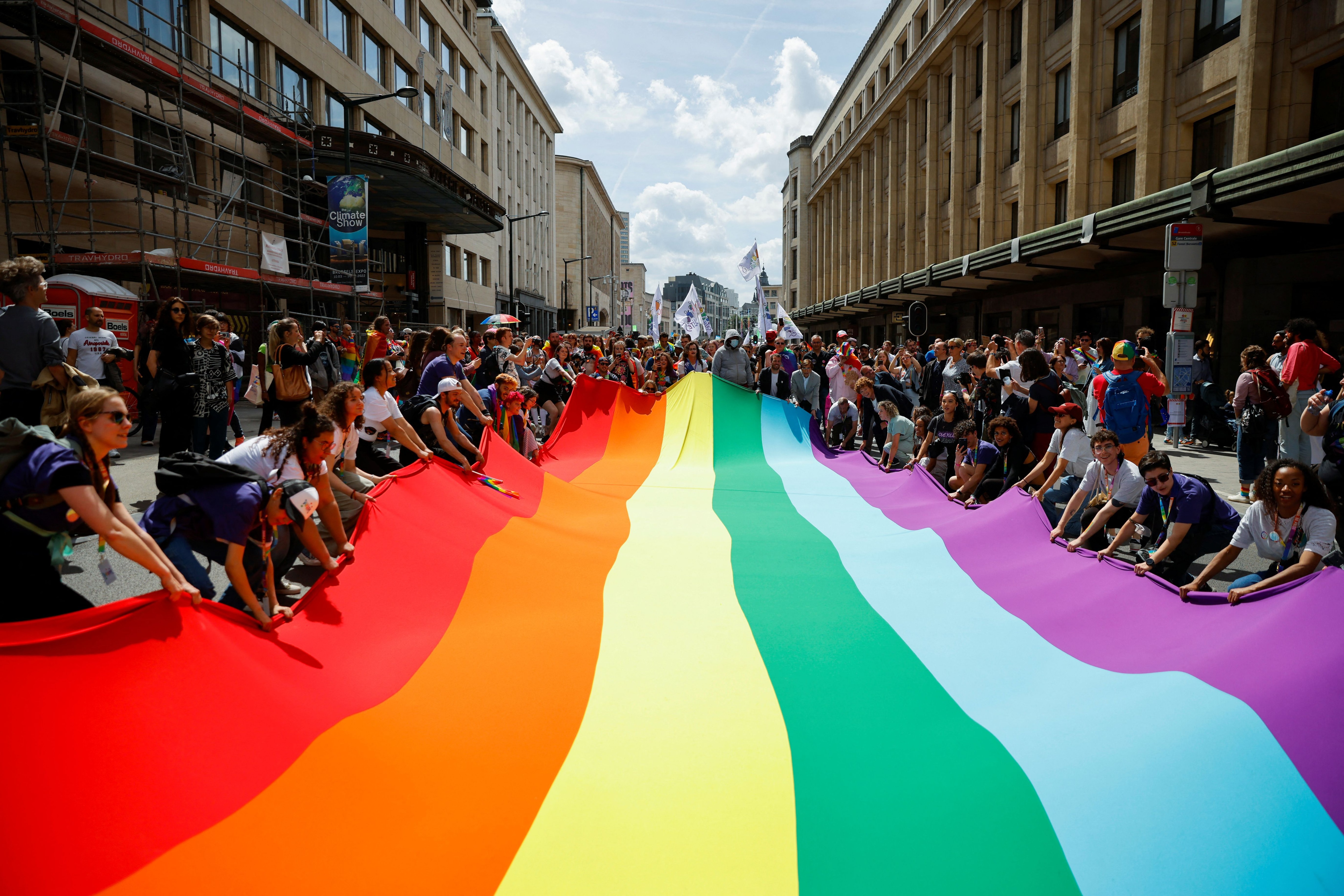 Participants unfold a rainbow flag during the annual Belgian LGBT Pride Parade in central Brussels, Belgium, May 21, 2022. REUTERS/Johanna Geron